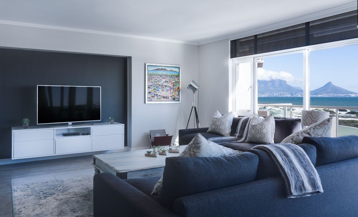 A living room with seating and a television