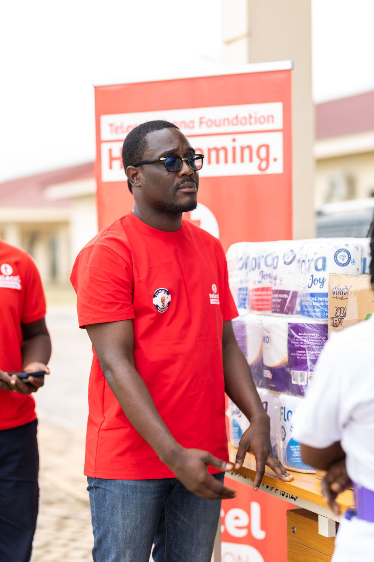 A volunteer distributing supplies at a community event