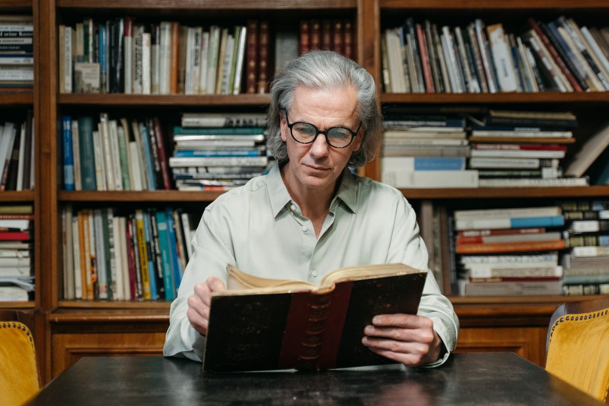 A reader surrounded by books